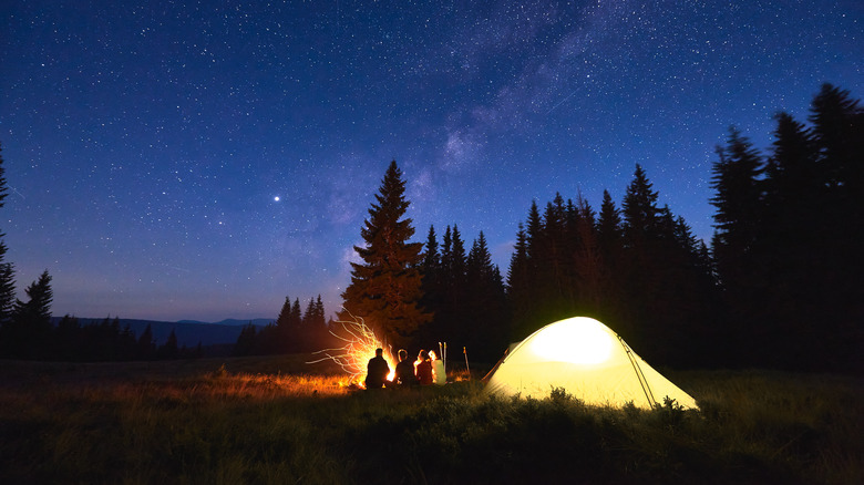 family camping under stars