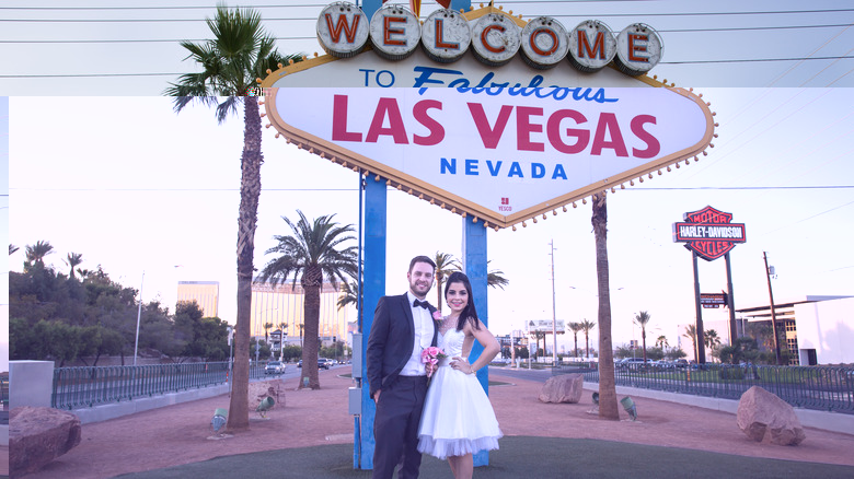 newlyweds at Las Vegas sign