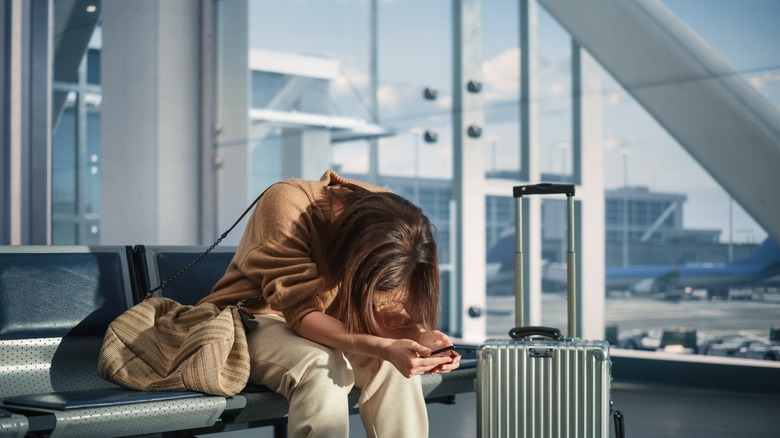 Woman looks stressed in airport