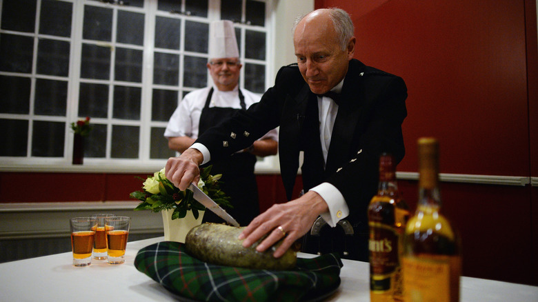 Man cutting haggis at Scotland Burns Night