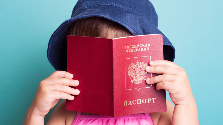 toddler holding passport 