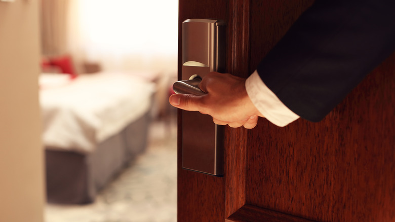 Hand opening hotel suite door