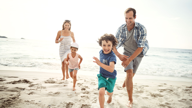 Family running on a beach