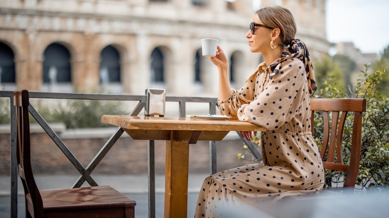 Woman drinking coffee in Italy