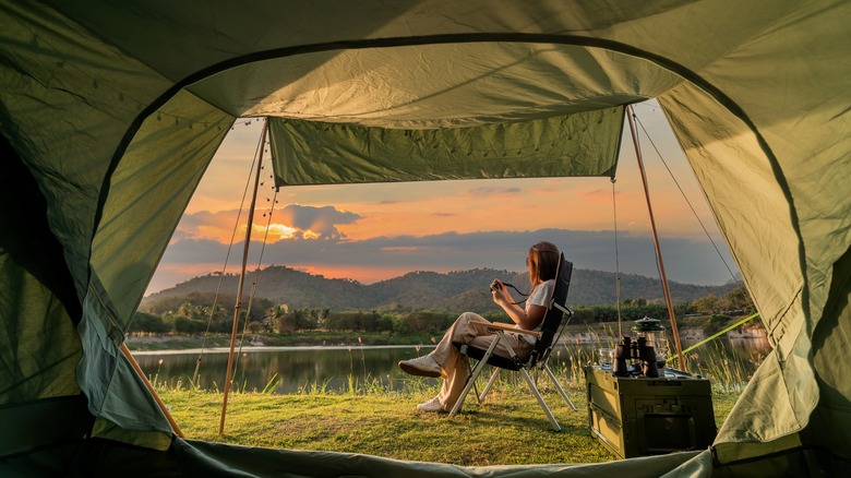 woman camping watching sunset