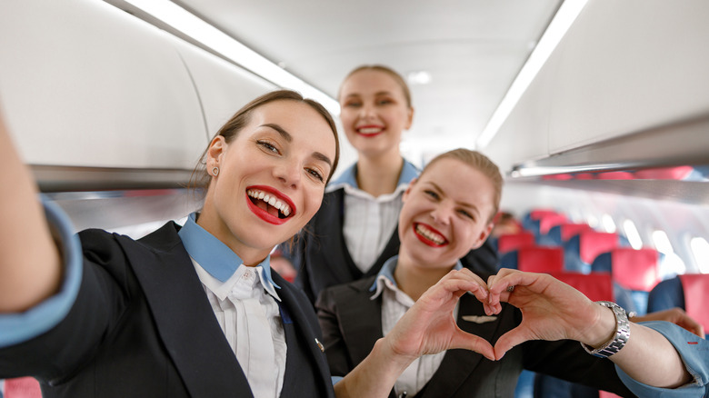 smiling flight attendants on plane