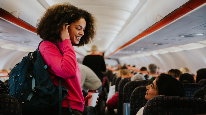 Two passengers talking aboard plane
