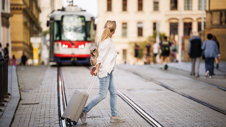 Tourist passing European tram