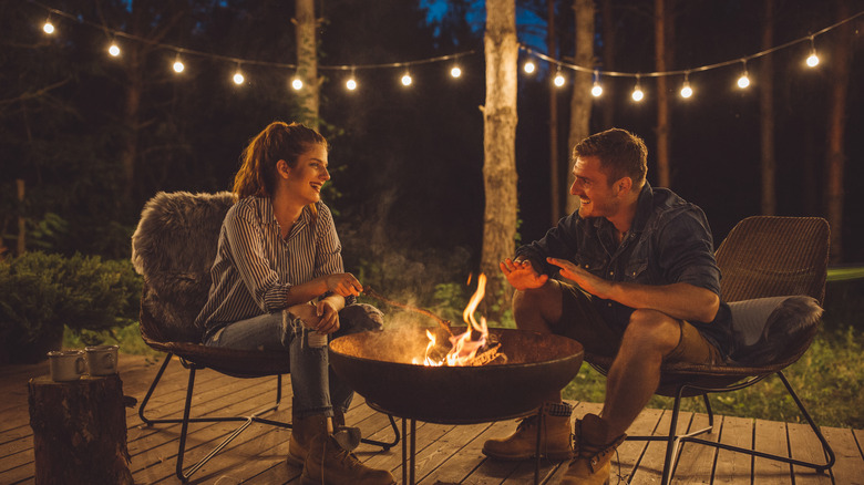 Couple sitting near a fire