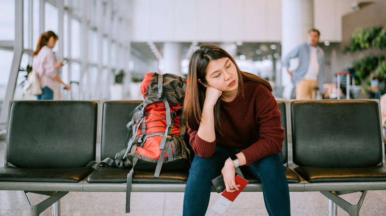 frustrated traveler sitting in airport