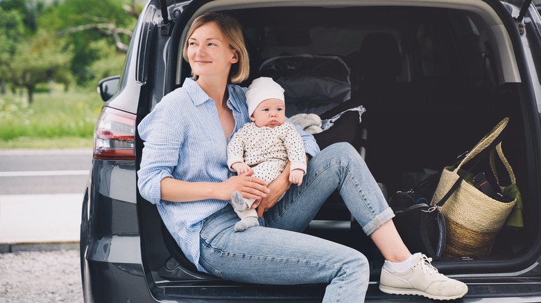 woman and baby with car