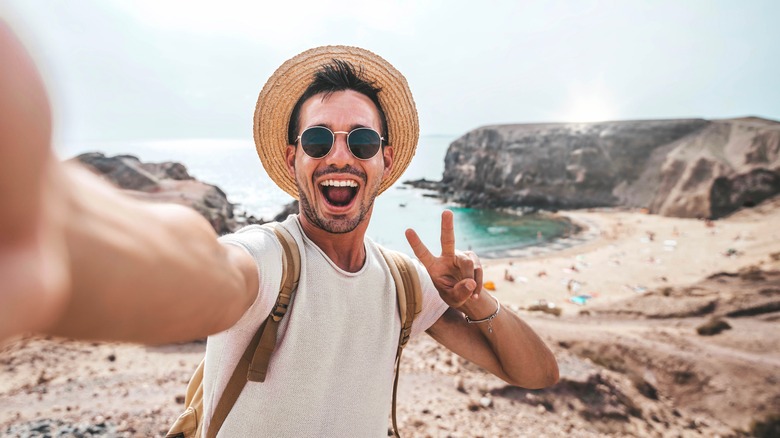 Traveler taking selfie at beach