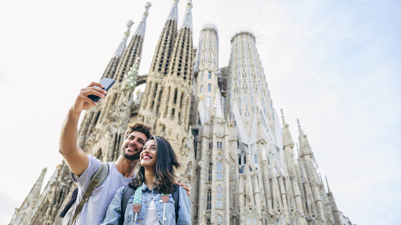 Young couple taking selfie at Sagrada Família