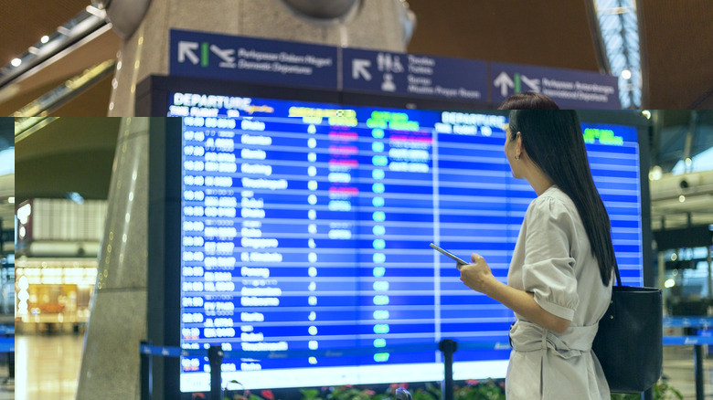 Woman looking at flight schedule screen