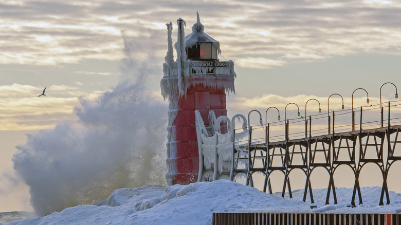 Frozen lighthouse crashing waves
