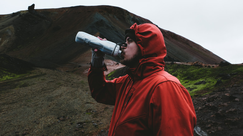 man drinking water in Iceland