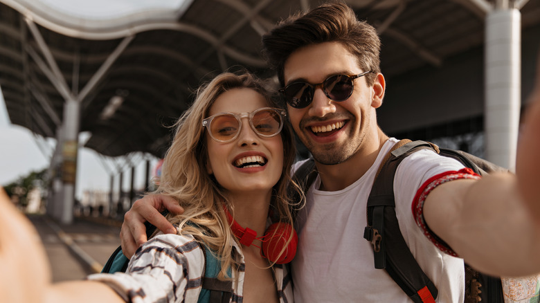 couple taking a selfie near airport